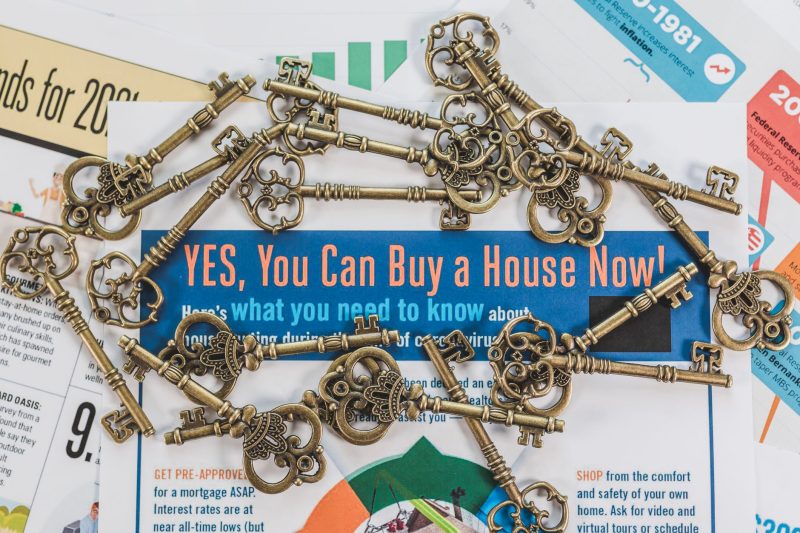 Blog 1 Vintage keys scattered over real estate documents, representing property ownership and investment.