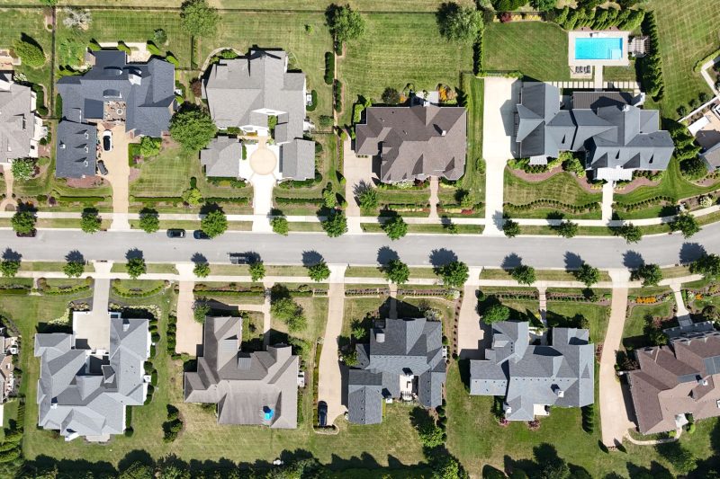Overhead view of modern homes surrounded by lush greenery in a suburban Tennessee neighborhood.